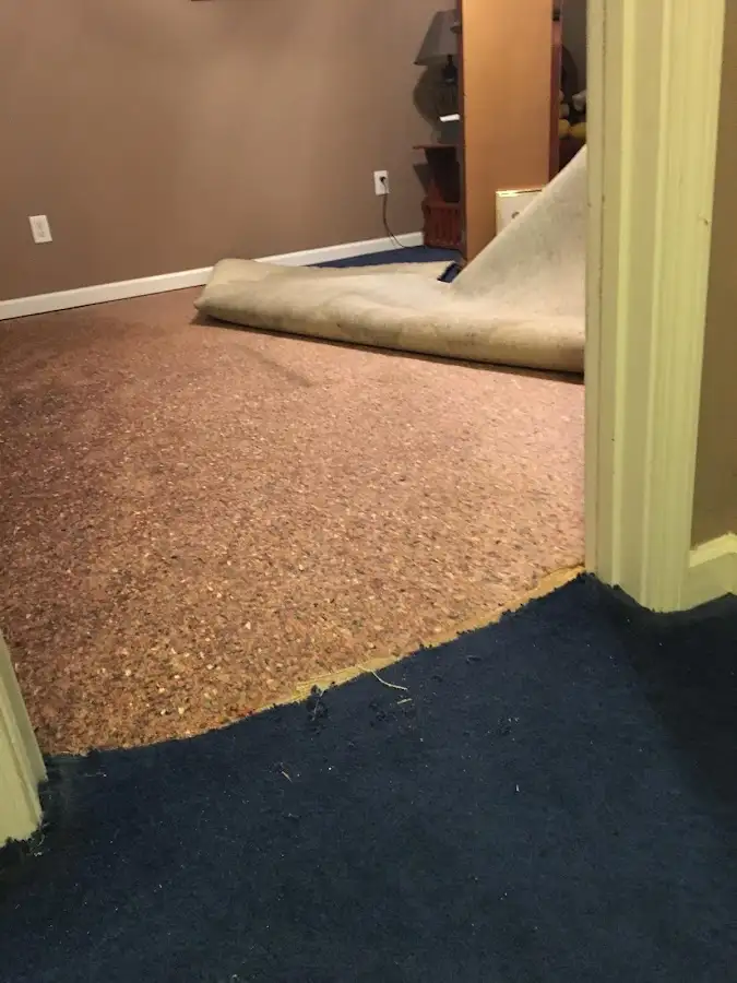 Carpet pad removal revealing water damage during Water Mitigation Services in Aberdeen